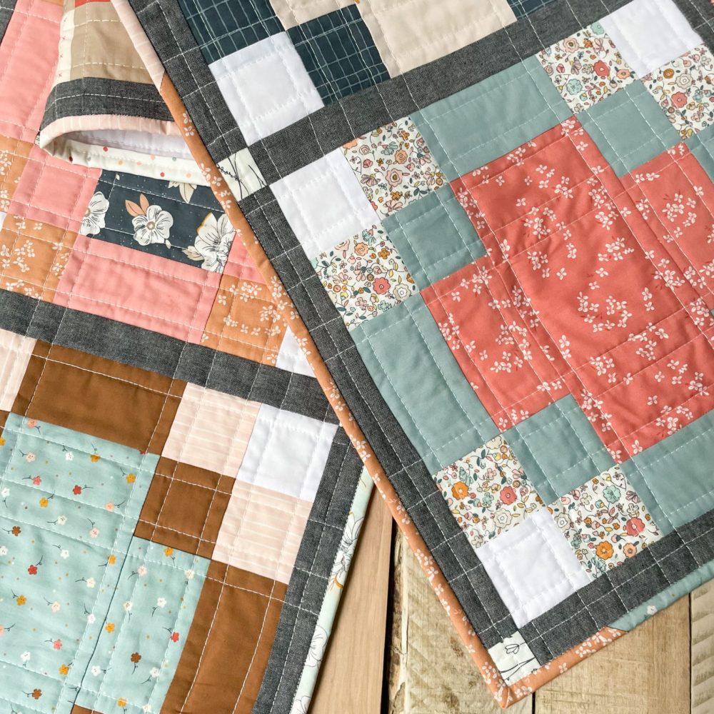 Handcrafted quilts featuring floral and geometric patterns by Heart Lake Quilts, showcasing cozy and colorful designs.