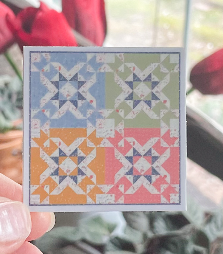 Colorful geometric quilt pattern with star shapes.