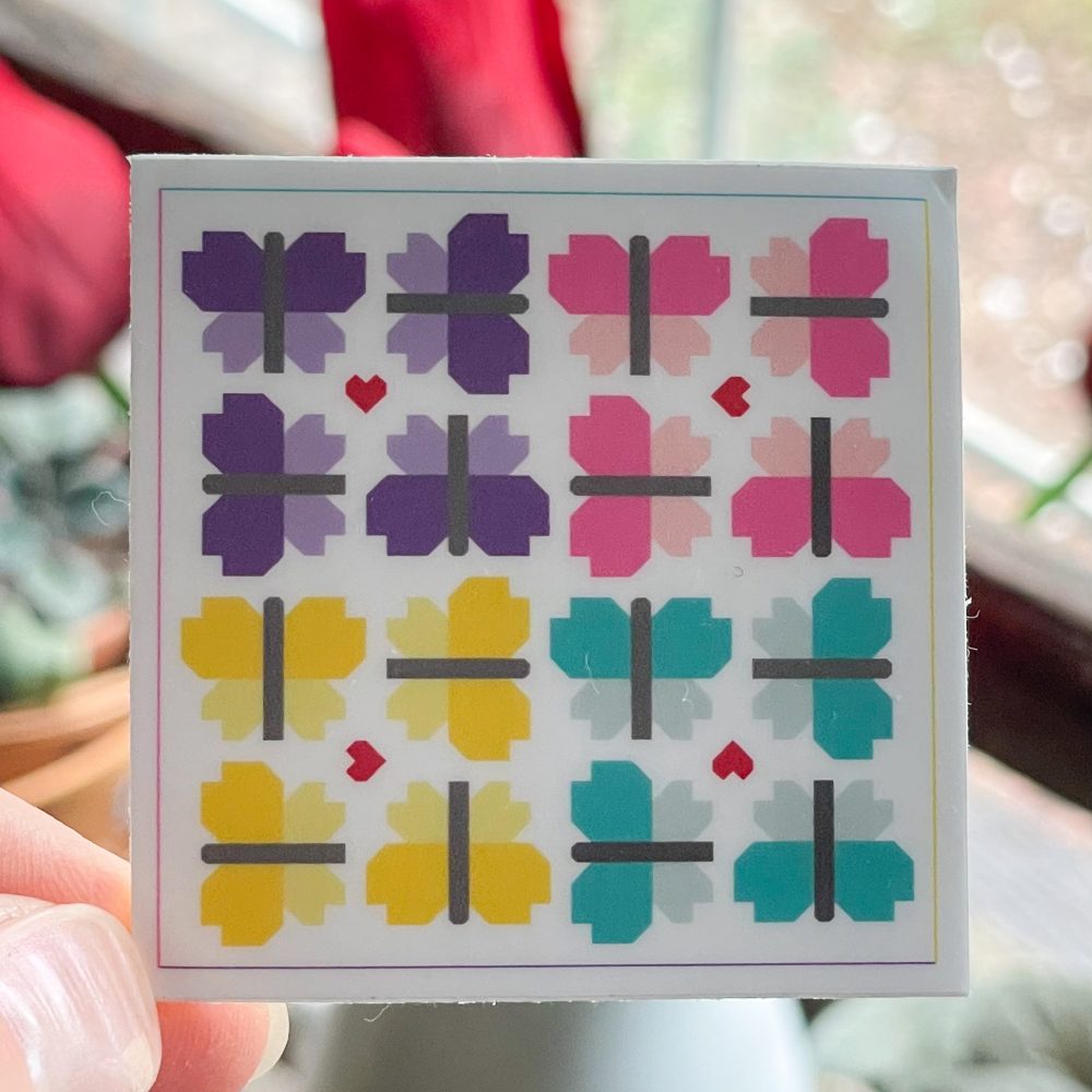 Colorful geometric sticker with hearts and crosses.